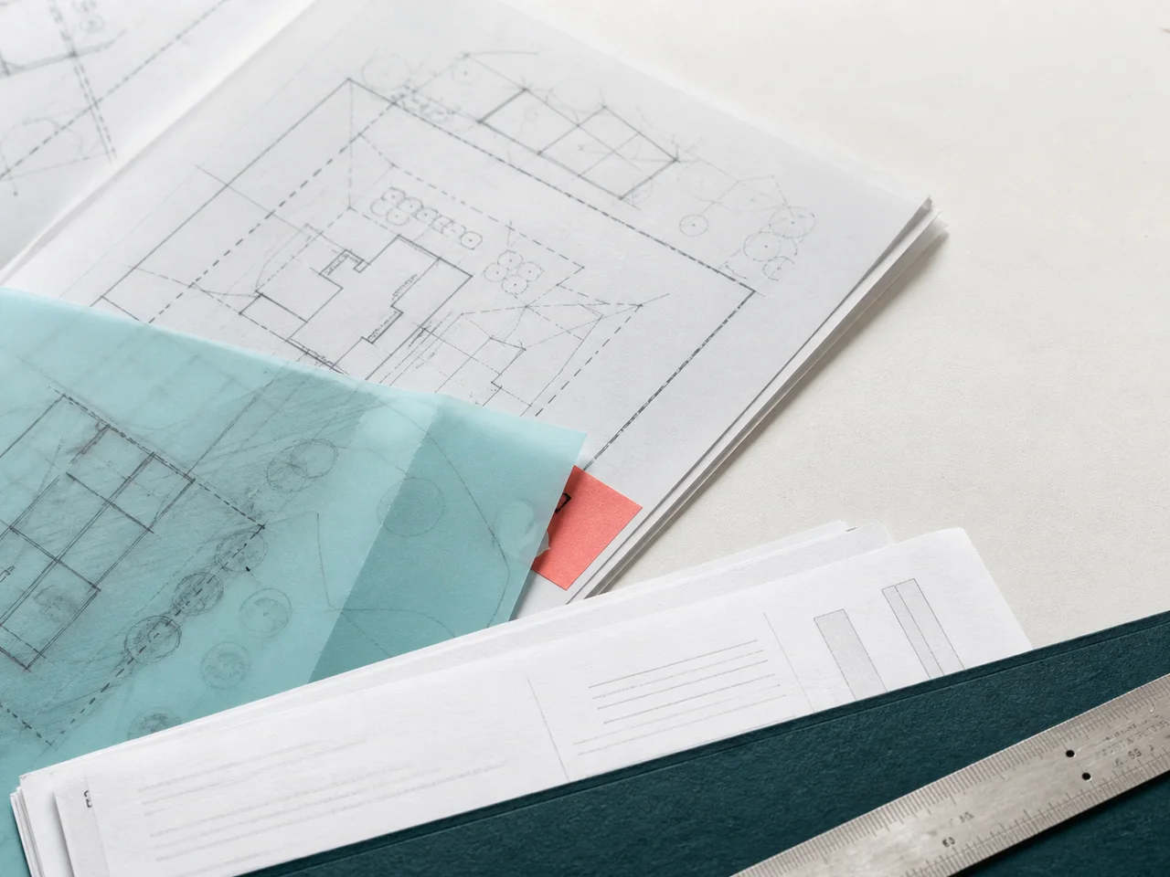 Property plans, transaction papers and a ruler arranged as a conveyancing cost ledger