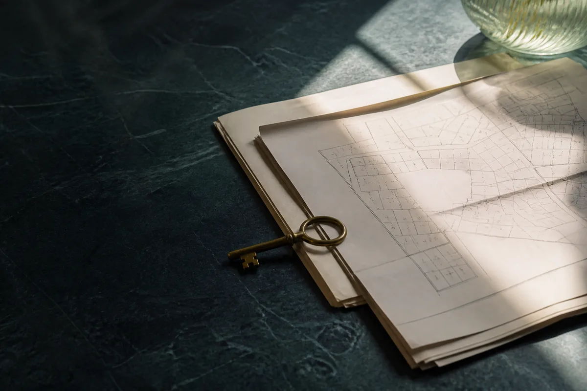 Property plans and a key arranged for a solicitor review